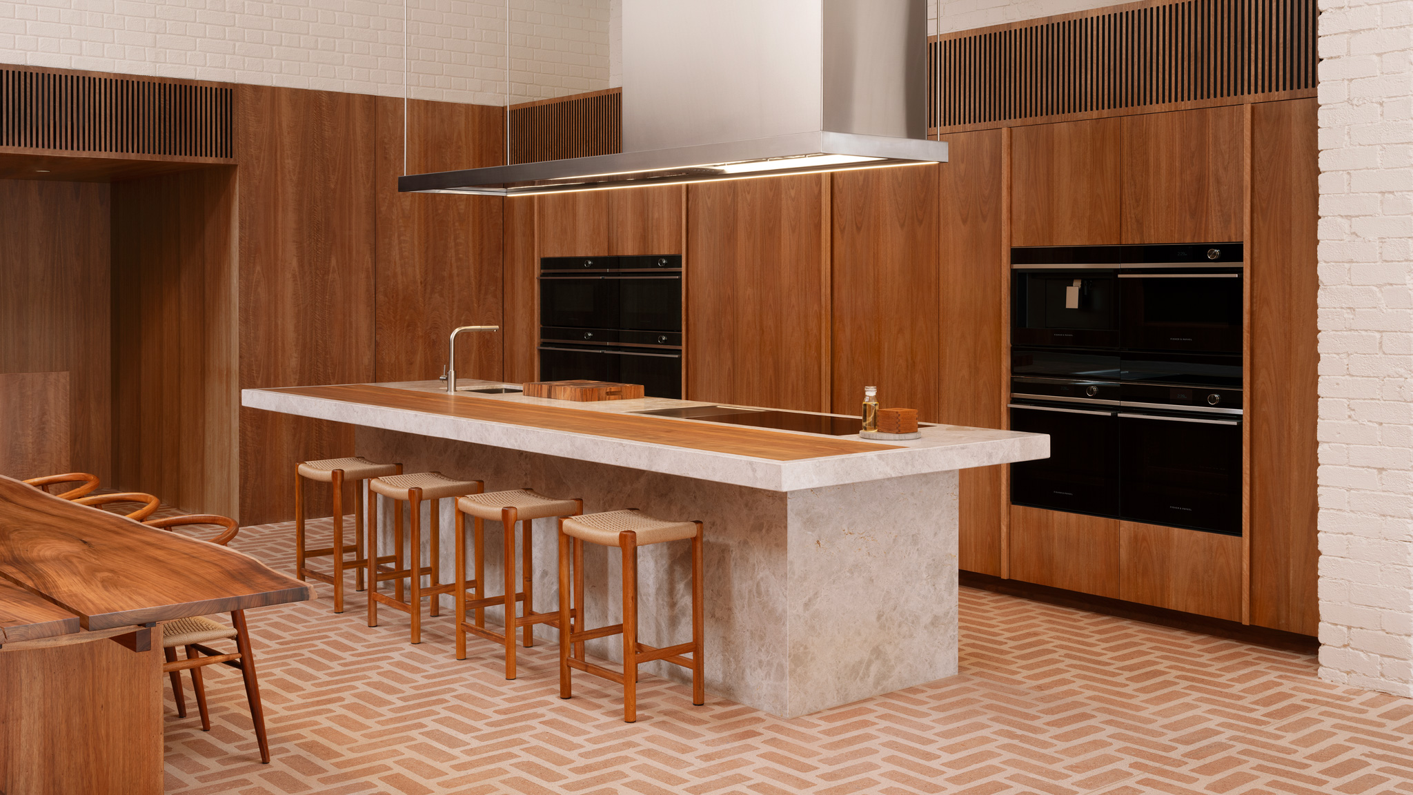 Custom terrazzo brick flooring installed in a herringbone pattern at the Fisher & Paykel Experience Centre designed by Claire Cousins Architects.